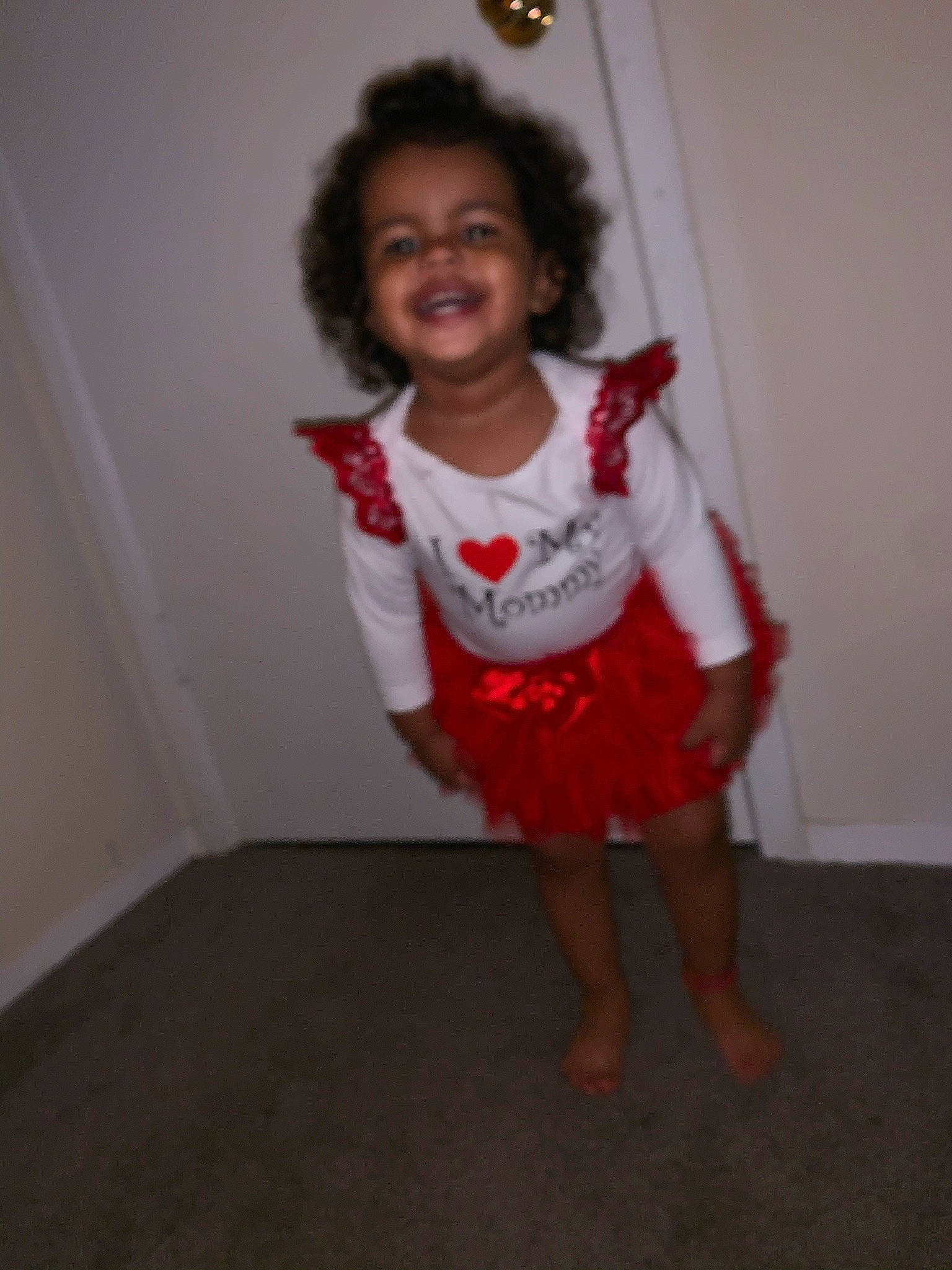 Avani is registered to the contest to win money with this photo: child, costume, dress, fun, head, joint, joy, person, shoulder, smile, standing, t_shirt, toddler, white