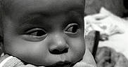 Ayan participe au concours pour gagner de l'argent avec cette photo : arm, baby, black_and_white, child, closeup, clothing, curious, cute, expression, face, head, indoors, infant, newborn, person, portrait, resting, skin, soft, young