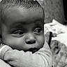 arm, baby, black_and_white, child, closeup, clothing, curious, cute, expression, face, head, indoors, infant, newborn, person, portrait, resting, skin, soft, young