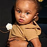 Jream joined the competition — help win amazing prizes! toddler, child, baby, person, face, golden_bow, hair_accessory, expression, curious, holding, arm, hand, clothing, tan_outfit, portrait, indoor, watch, star_tattoo, skin, cute