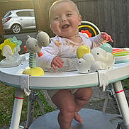 Eddyson is registered to the contest to win money with this photo: activity_center, baby, background, child, clothing, daylight, face, feet, grass, happy, messy, outdoor, person, plastic, play, residential, smiling, sunlight, toy, walker