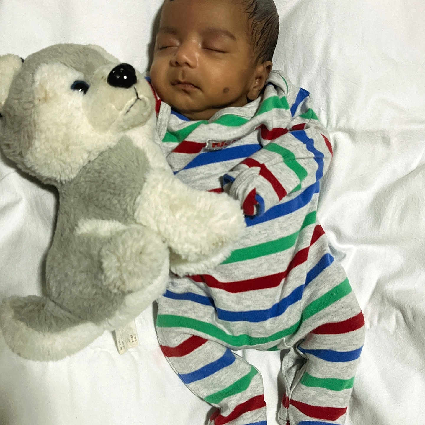 Arjun is registered to the contest to win money with this photo: baby, bed, blanket, bodypart, clothing, couch, cushion, face, furniture, head, homedecor, newborn, pajamas, person, photography, plush, portrait, sleeping, teddybear, toy