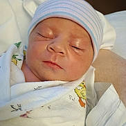 Allison is registered to the contest to win money with this photo: newborn, baby, sleeping, hat, blanket, wrapped, infant, closeup, face, peaceful, soft, cute, skin, person, resting, indoors, comfort, headwear, newborn_baby, swaddled