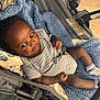 baby, baby_clothes, blanket, carriage, child, comfort, curious, cute, fabric, floor, indoor, infant, onesie, person, seat, socks, soft_texture, striped_clothing, stroller, young_child