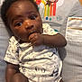 Michael joined the competition — help win amazing prizes! baby, infant, child, onesie, animal_print, hand_in_mouth, baby_seat, rainbow, monkey, colorful, cute, wide_eyes, indoor, soft_lighting, portrait, sitting, young_child, expression, clothing, wooden_floor