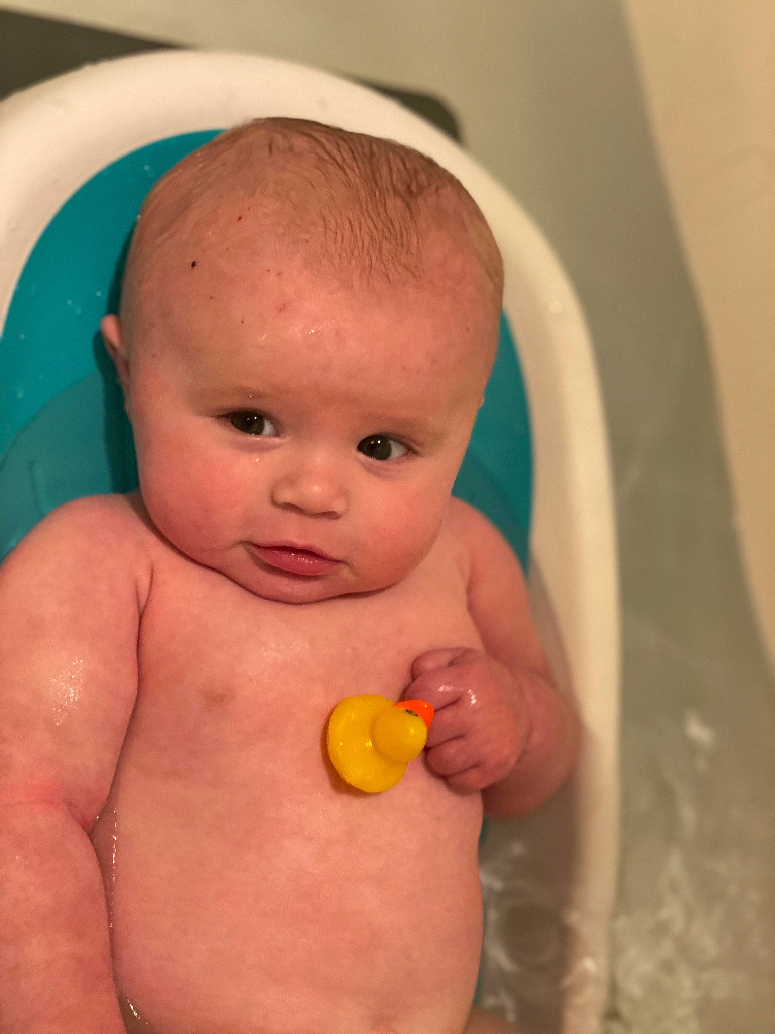 Camden is registered to the contest to win money with this photo: baby, baby_bathing, baby_products, bathing, bathtub, cheek, child, eye, face, head, person, plumbing_fixture, product, rubber_ducky, skin, toddler