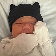 Zayla is registered to the contest to win money with this photo: baby, blanket, child, closeup, cozy, cute, face, hat, headwear, indoors, infant, mittens, newborn, peaceful, portrait, rest, sleeping, soft, tiny, warm