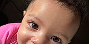 Truee joined the competition — help win amazing prizes! baby, child, curly_hair, smiling, face, pink_clothing, blanket, portrait, close_up, cute, indoors, infant, happy, soft_texture, young_child, skin, person, eyelashes, head, warmth