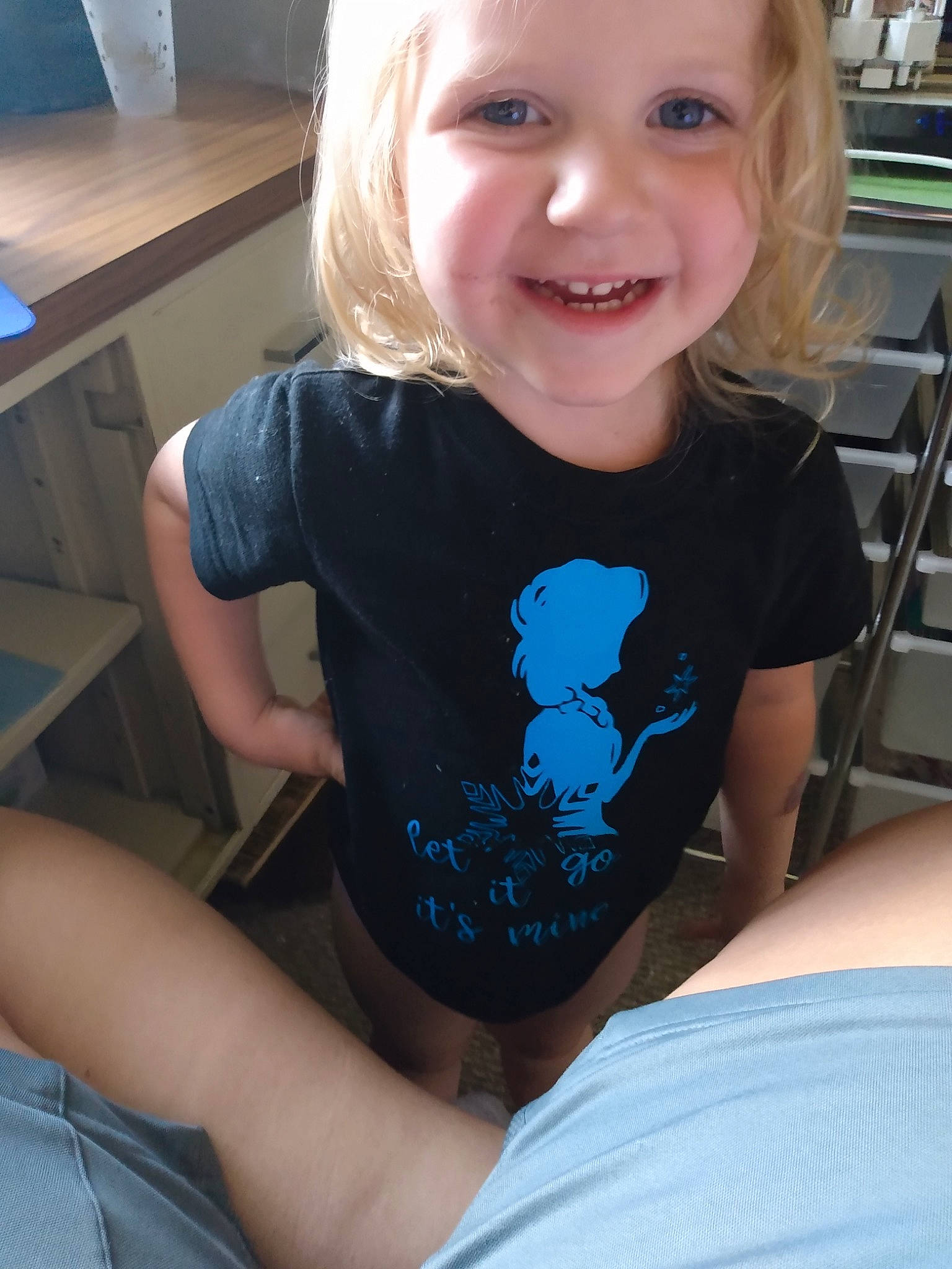 Elena is registered to the contest to win money with this photo: arm, blond, child, headwear, joy, leg, neck, person, shoulder, sleeve, smile, t_shirt, thigh, toddler, top