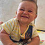baby, child, smiling, happy, playmat, striped_shirt, fish_design, hands, fingers, cute, infant, crawling, indoors, soft_surface, chubby_cheeks, wild_hair, joyful, closeup, portrait, person