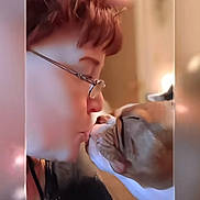 Leo Aloyisus Mket is registered to the contest to win money with this photo: person, dog, glasses, face, close_up, indoor, interaction, affection, pet, wrinkles, nose, love, human, animal, bond, cute, intimate, close_contact, warm_light, gentle