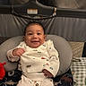 Mathias joined the competition — help win amazing prizes! baby, infant, child, smiling, portrait, sitting, bouncer, baby_seat, cushion, blanket, onesie, patterned_clothing, toy, teether, nursery, indoors, cozy, happy, face, photography