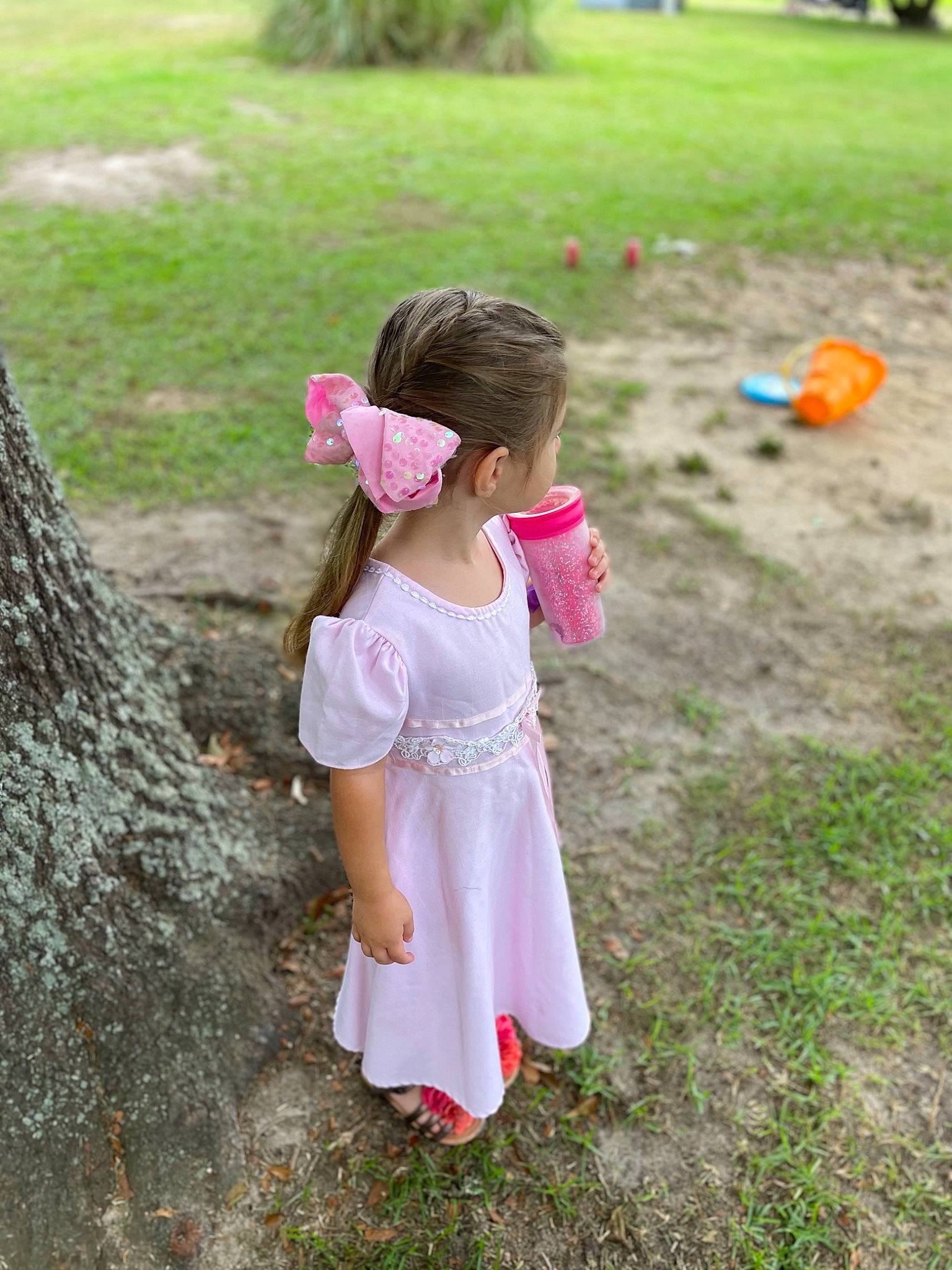 Adalyn is registered to the contest to win money with this photo: baby_toddler_clothing, botany, child, day_dress, fun, garden, grass, grass_family, grassland, happy, hat, leisure, magenta, people_in_nature, person, pink, plant, recreation, summer, toddler