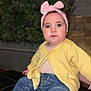 Salmah Pérez Acosta is registered to the contest to win money with this photo: baby, child, headband, pink, yellow_cardigan, jeans, sitting, indoor, curious_expression, face, hands, foot, clothing, portrait, cute, infant, person, casual, closeup, young