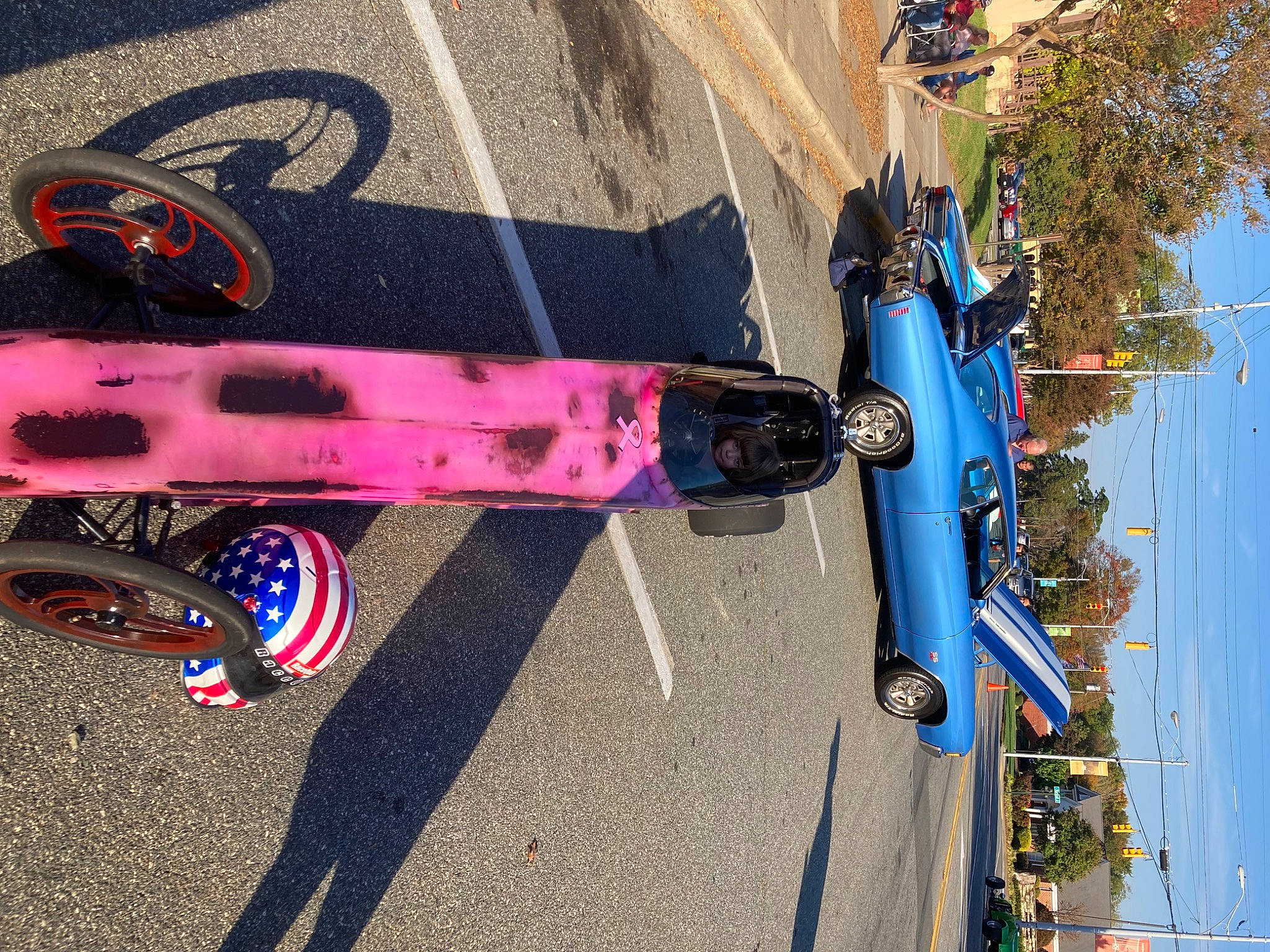 Cheyenne joined the competition — help win amazing prizes! art, asphalt, automotive_exterior, automotive_lighting, automotive_tire, bicycle_tire, blue, car, eyewear, line, motor_vehicle, person, road_surface, sidewalk, skateboard, sky, sports_equipment, tire, tree, vehicle