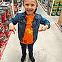 Lucas a rejoint le concours — aidez-le/la à gagner de superbes lots ! child, boy, smiling, denim_jacket, orange_hoodie, pikachu, cap, shoes, hardware_store, aisle, floor, shelves, paint_cans, fire_extinguisher, clothing, person, happy, casual, indoor, retail