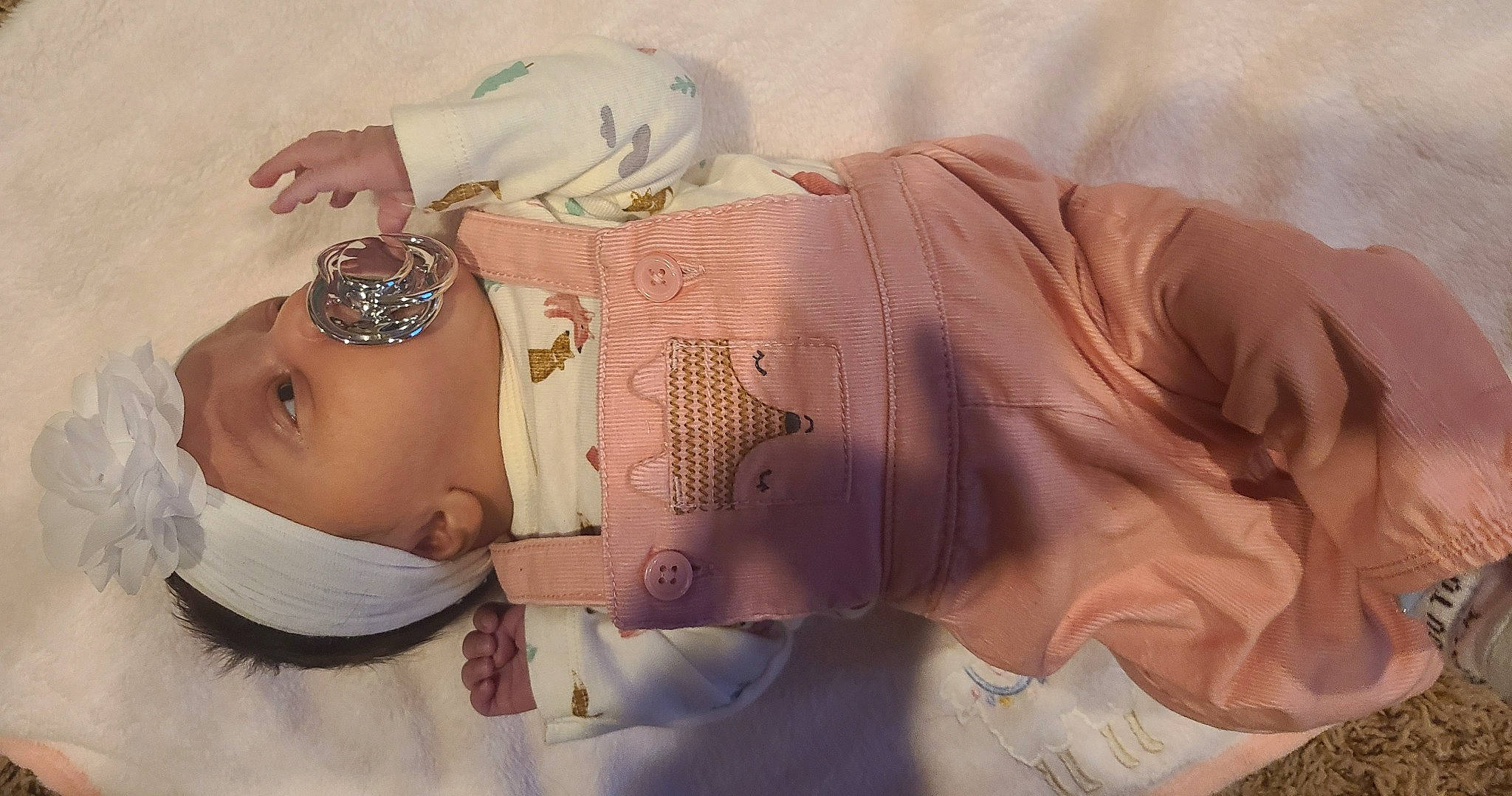 Emmilia is registered to the contest to win money with this photo: arm, chest, chin, dress, eyelash, finger, glasses, hair, hairstyle, hand, head, headgear, headwear, human_body, lip, mouth, neck, person, pink, skin