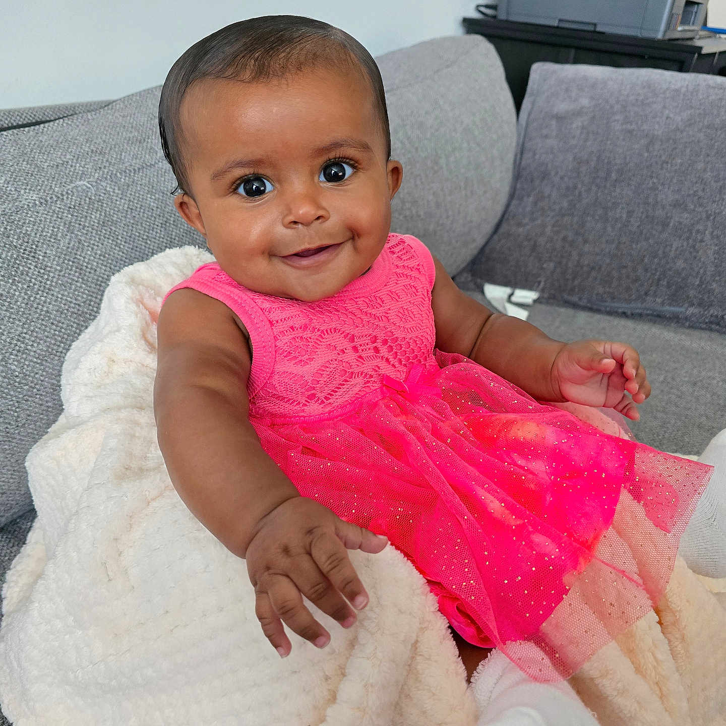 Zoey joined the competition — help win amazing prizes! baby, child, infant, portrait, smiling, happy, sitting, pink_dress, dress, blanket, sofa, couch, indoor, home, facial_expression, brown_eyes, short_hair, baby_shoes, furniture, photography