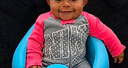 Zoey is registered to the contest to win money with this photo: baby, child, infant, smiling, portrait, sitting, blue_chair, pink_sleeves, gray_outfit, black_blanket, indoor, window, window_blinds, happy, cute, face, eyes, short_hair, baby_clothing, photography