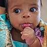 Zoey joined the competition — help win amazing prizes! baby, infant, child, portrait, close_up, face, eyes, blue_eyes, hand, fist, sucking_fingers, curious, indoor, blanket, colorful, pink_clothing, wrapped, sitting, photography, cute