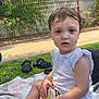 Yasmine a rejoint le concours — aidez-le/la à gagner de superbes lots ! blanket, casual_clothing, child, curly_hair, daylight, expression, face, footwear, garden, grass, greenery, nature, outdoor, playtime, sandals, sitting, summer, toddler, toy, young_child