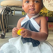 Luna joined the competition — help win amazing prizes! black_bow, celebration, chair, child, cute, dress, floor, hair_bows, indoors, party, person, pink_bows, portrait, sitting, socks, toddler, toy, white_dress, yellow_toy, young_child