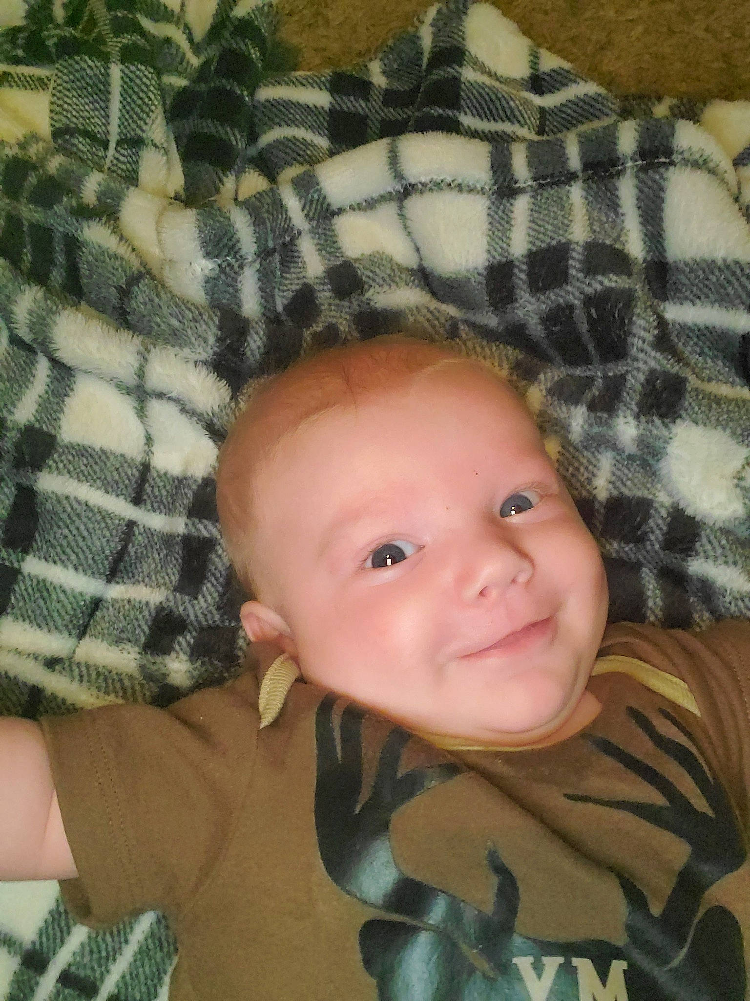 Hunter is registered to the contest to win money with this photo: baby, cheek, child, design, face, forehead, head, joy, lip, mouth, nose, pattern, person, plaid, toddler