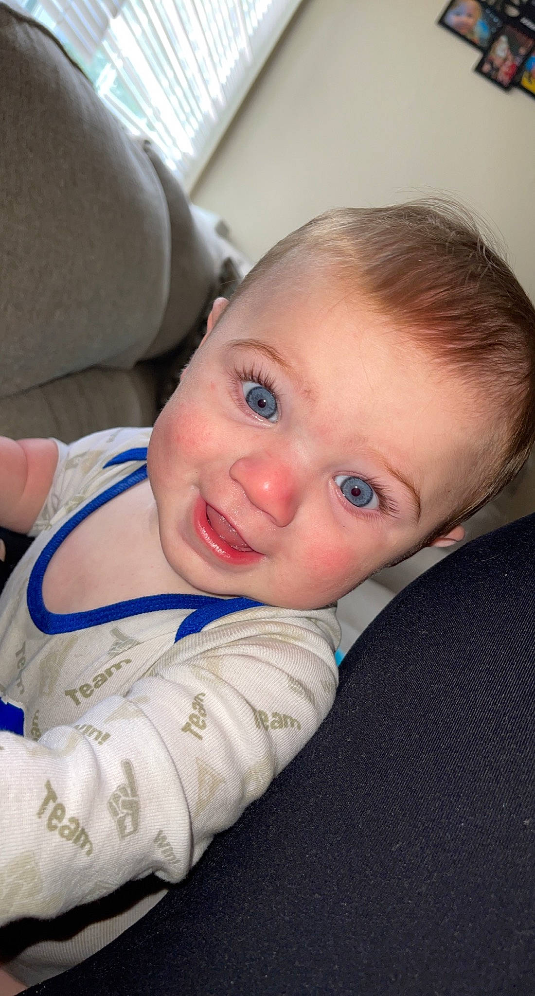 Parker is registered to the contest to win money with this photo: baby, baby_toddler_clothing, cheek, child, comfort, ear, face, finger, fun, gesture, happy, head, iris, mouth, nose, person, sitting, skin, smile, thumb