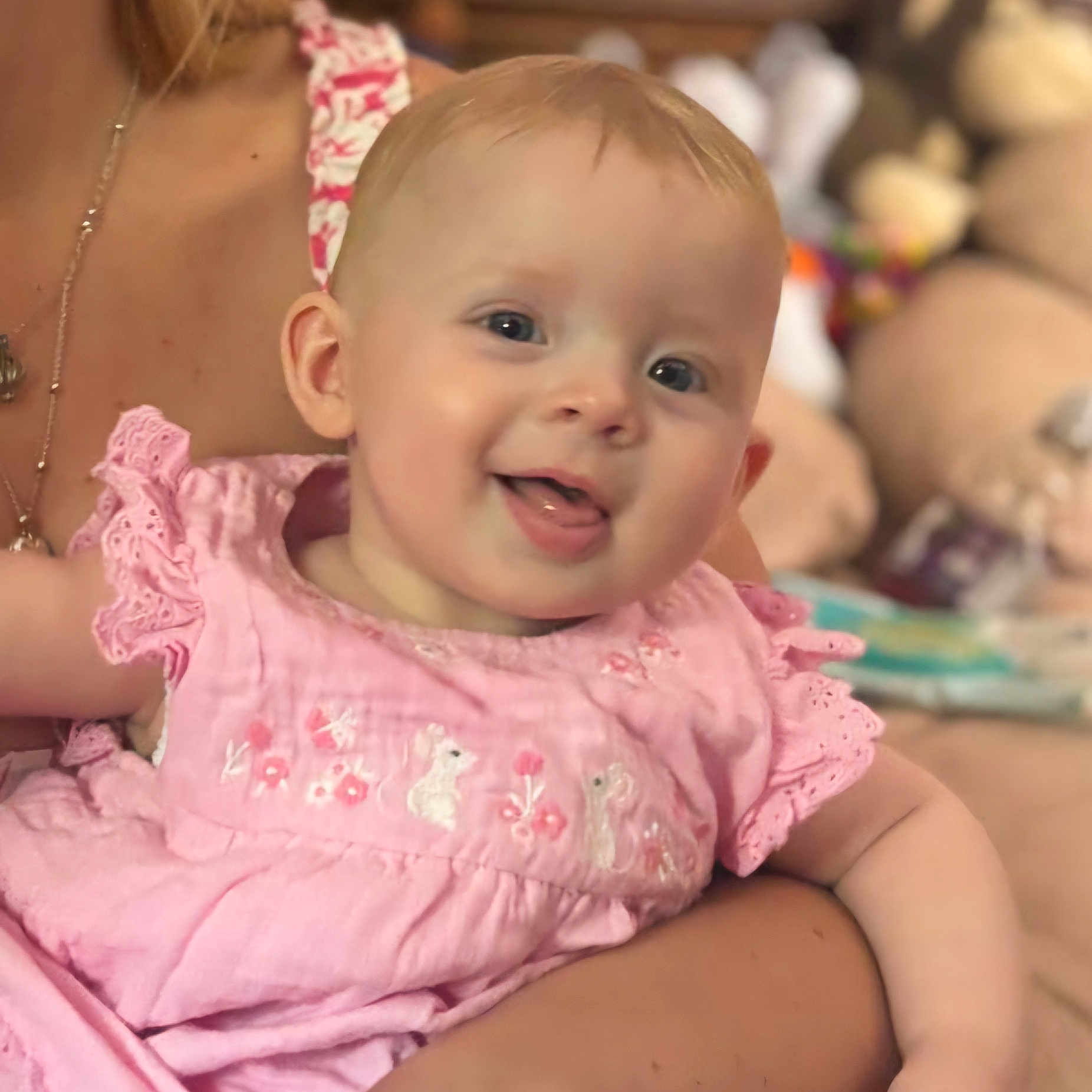 Jennifer joined the competition — help win amazing prizes! apparel, arm, baby, child, childhood, closeup, cute, face, happy, holding, human, indoor, infant, person, pink_dress, portrait, skin, smiling, soft_focus, tongue_out