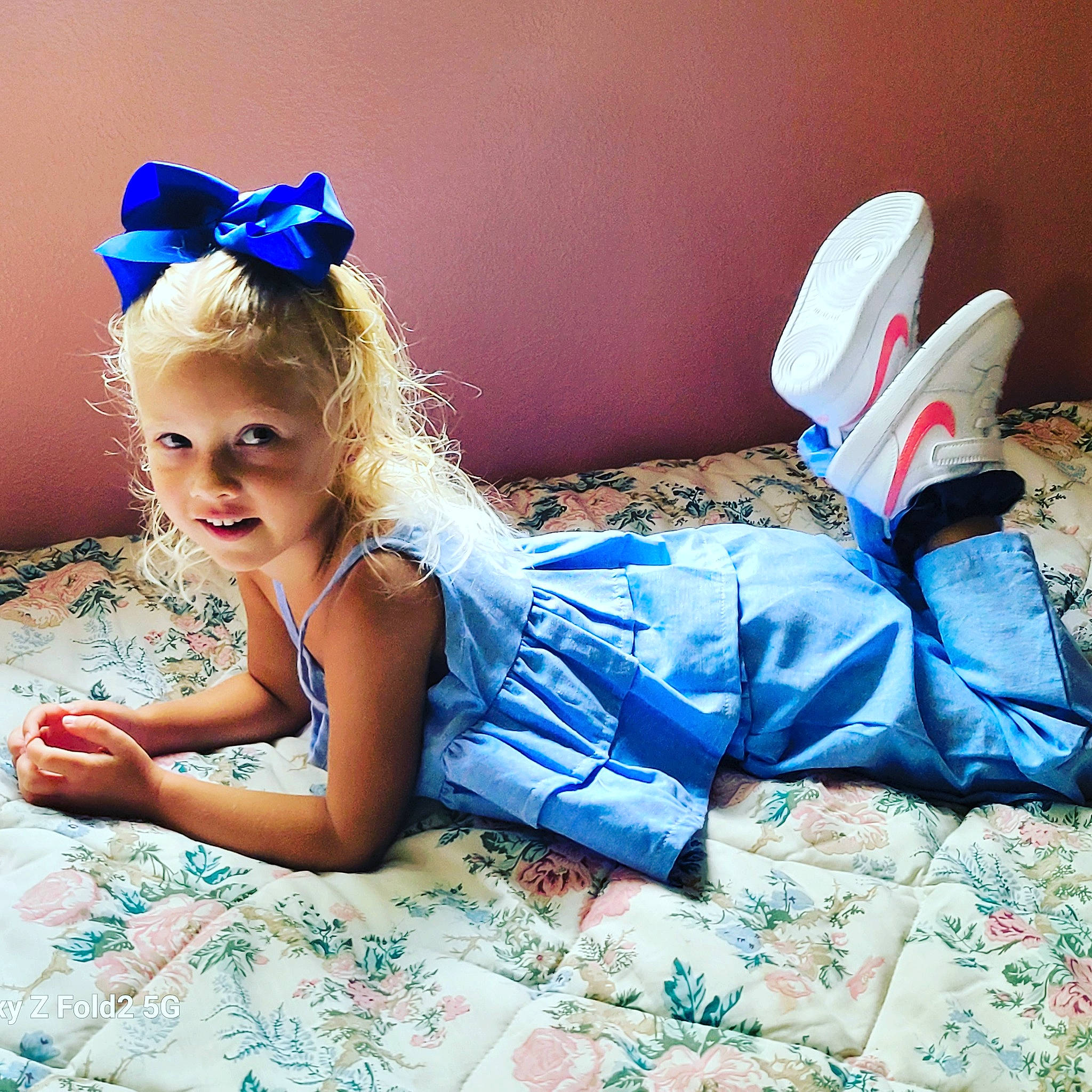 Kerry is registered to the contest to win money with this photo: blond, blue, child, cool, electric_blue, fashion, flash_photography, fun, happy, headband, headpiece, human_leg, leg, leisure, person, sitting, smile, textile, thigh, toddler