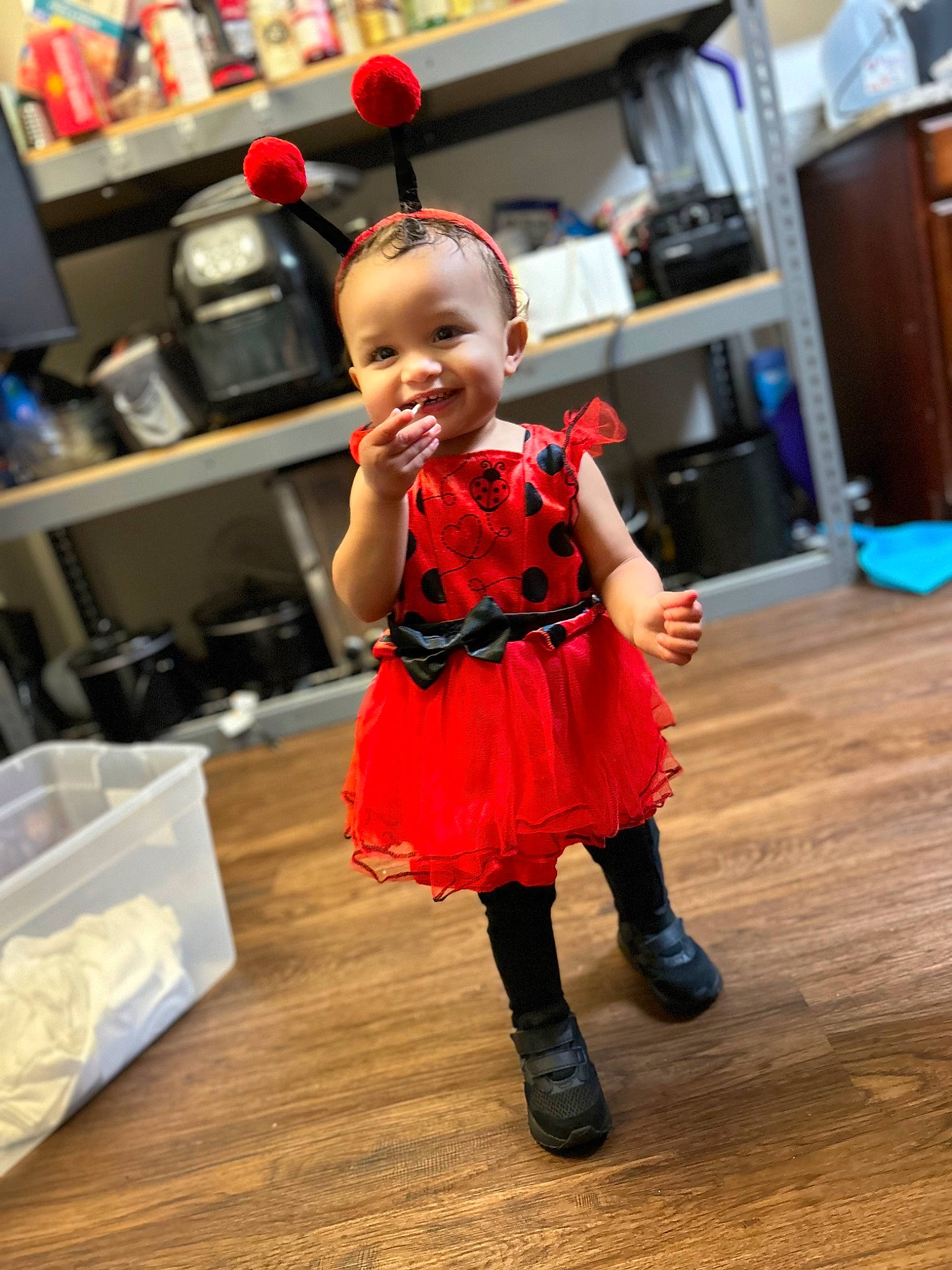 Jhariah is registered to the contest to win money with this photo: baby, baby_toddler_clothing, child, dress, event, fashion_design, flooring, fun, happy, hardwood, hat, home_appliance, joy, kitchen_appliance, person, plastic_bag, shelf, smile, standing, television