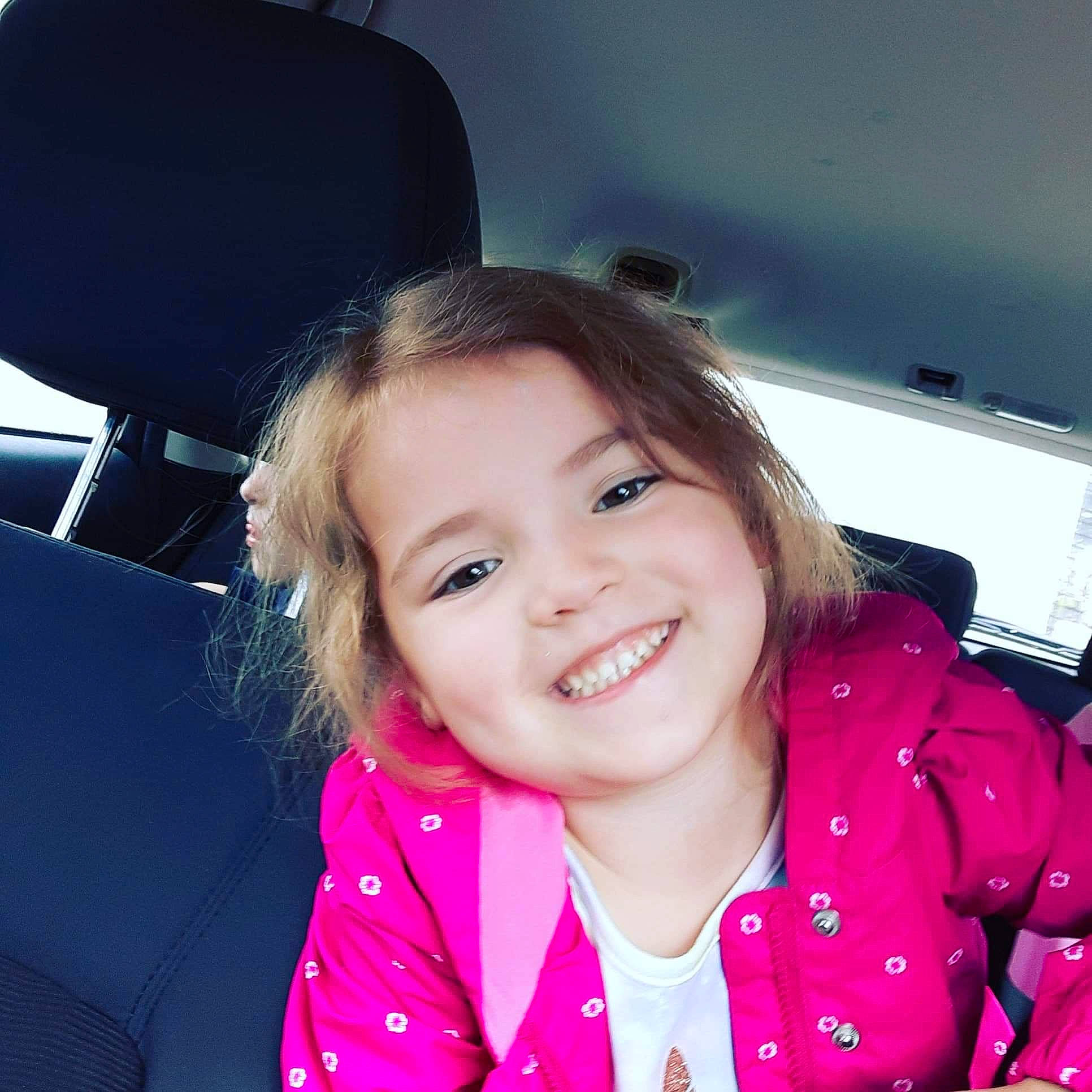 Gracelynn joined the competition — help win amazing prizes! black_hair, car_seat_cover, cool, flash_photography, fun, gesture, hairstyle, happy, head_restraint, iris, joy, lip, material_property, person, skin, sleeve, smile, steering_wheel, thumb, toddler