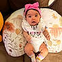 baby, bib, bow, brown, child, comfortable, couch, cute, floral_pillow, happy, headband, indoors, infant, minnie_mouse, person, pink, portrait, relaxed, smiling, socks