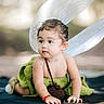 Mary Queen Jida is registered to the contest to win money with this photo: baby, child, fairy_wings, crawling, green_outfit, knitted_clothing, curious, cute, bracelet, natural_light, outdoor, portrait, soft_background, infant, small_bag, adorable, young_child, baby_fashion, playful, headwear