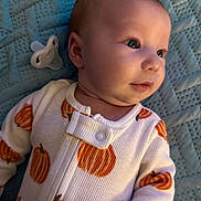 Bryer joined the competition — help win amazing prizes! baby, infant, onesie, pumpkin_pattern, pacifier, blue_blanket, face, head, skin, clothing, sleepwear, cute, child, lying_down, soft_texture, closeup, indoors, expression, newborn, comfort