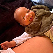 Bellamy joined the competition — help win amazing prizes! baby, bib, blanket, clothing, comfort, cozy, cute, expression, face, hand, happy, indoors, infant, lying_down, person, relaxing, skin, smile, toddler, young