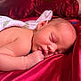 newborn, baby, sleeping, face, skin, arm, hand, fabric, satin, red, blanket, soft, peaceful, closeup, infant, wrapped, resting, cute, portrait, indoors