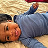 Rashaad joined the competition — help win amazing prizes! baby, bed, blue_clothing, child, cozy, curly_hair, cute, expression, face, indoors, infant, lying_down, one_person, playful, portrait, resting, skin, smile, tongue_out, young_child