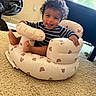 Rashaad joined the competition — help win amazing prizes! baby, carpet, chair, child, curly_hair, cute, footwear, greenery, happy, home, indoor, infant, inflatable_seat, natural_light, person, playful, smiling, striped_clothing, teddy_bear_pattern, window