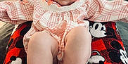 Scarlett joined the competition — help win amazing prizes! baby, infant, child, pink_clothing, plaid, legs, blanket, mickey_mouse, red, black, indoor, carpet, door, wall_outlet, smiling, face, feet, toes, person, home