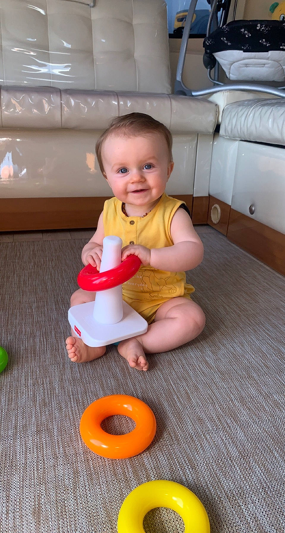 Aroys a rejoint le concours — aidez-le/la à gagner de superbes lots ! baby, baby_playing_with_toys, baby_toddler_clothing, child, chin, floor, flooring, fun, human_body, joy, leg, mouth, orange, person, riding_toy, smile, thigh, tire, toddler, toy