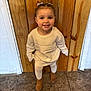 Zaylin is registered to the contest to win money with this photo:  doorway, boots, brown_hair, candid, casual_clothing, child, girl, hair_bow, happy_expression, indoor, one_person, portrait, smile, standing, sweater, tights, tile_floor, toddler, wooden_door, young_child