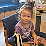 Hope is registered to the contest to win money with this photo: child, girl, hospital, arm_brace, iv_line, chair, purple_dress, frozen_character, messy_bun, toy_doll, water_bottle, medical, indoors, person, furniture, calm, sitting, young, healthcare, brave