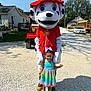 Gracelynn joined the competition — help win amazing prizes! child, mascot, costume, dalmatian, firefighter, outdoor, daylight, dress, rainbow_dress, smile, grass, gravel, car, school_bus, house, person, shadow, sunny, event, fun