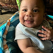 Xaivius joined the competition — help win amazing prizes! baby, smile, blanket, indoor, child, happy, face, curly_hair, clothing, infant, cute, portrait, closeup, skin, hand, sitting, cozy, warm, expression, person