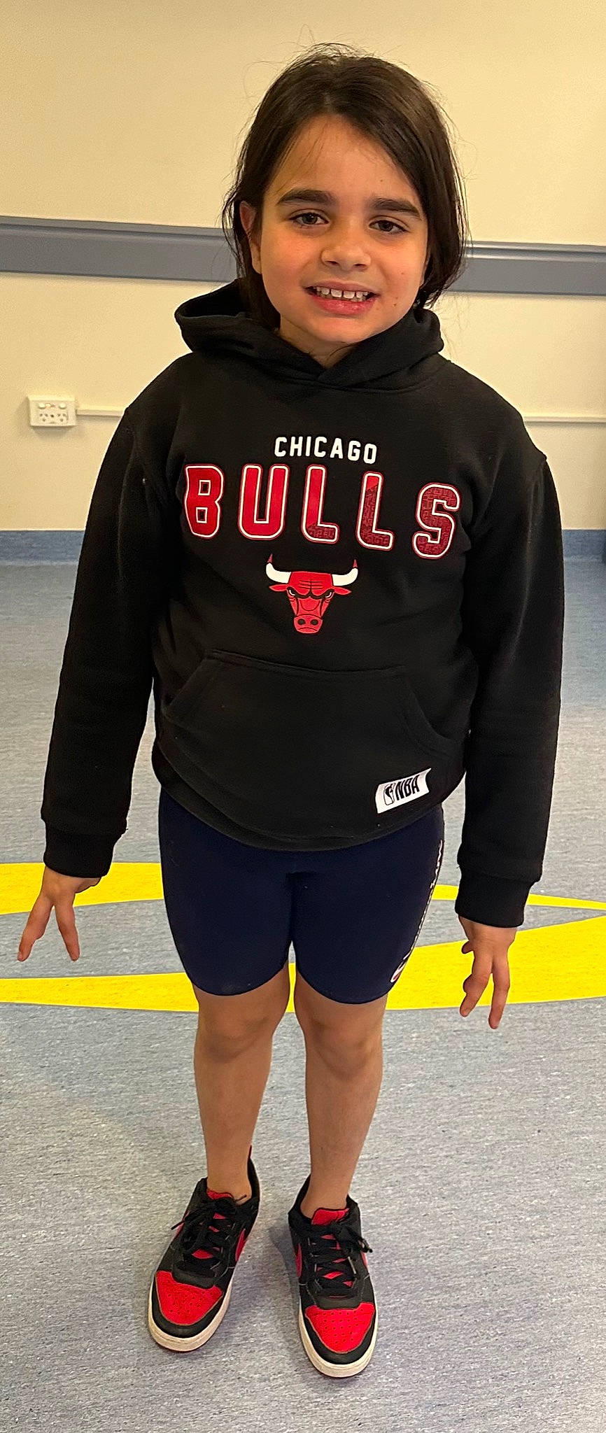 Tia is registered to the contest to win money with this photo: cap, electric_blue, fun, human_leg, jersey, joint, joy, knee, leg, orange, outerwear, person, personal_protective_equipment, player, sleeve, smile, sportswear, standing, t_shirt, thigh