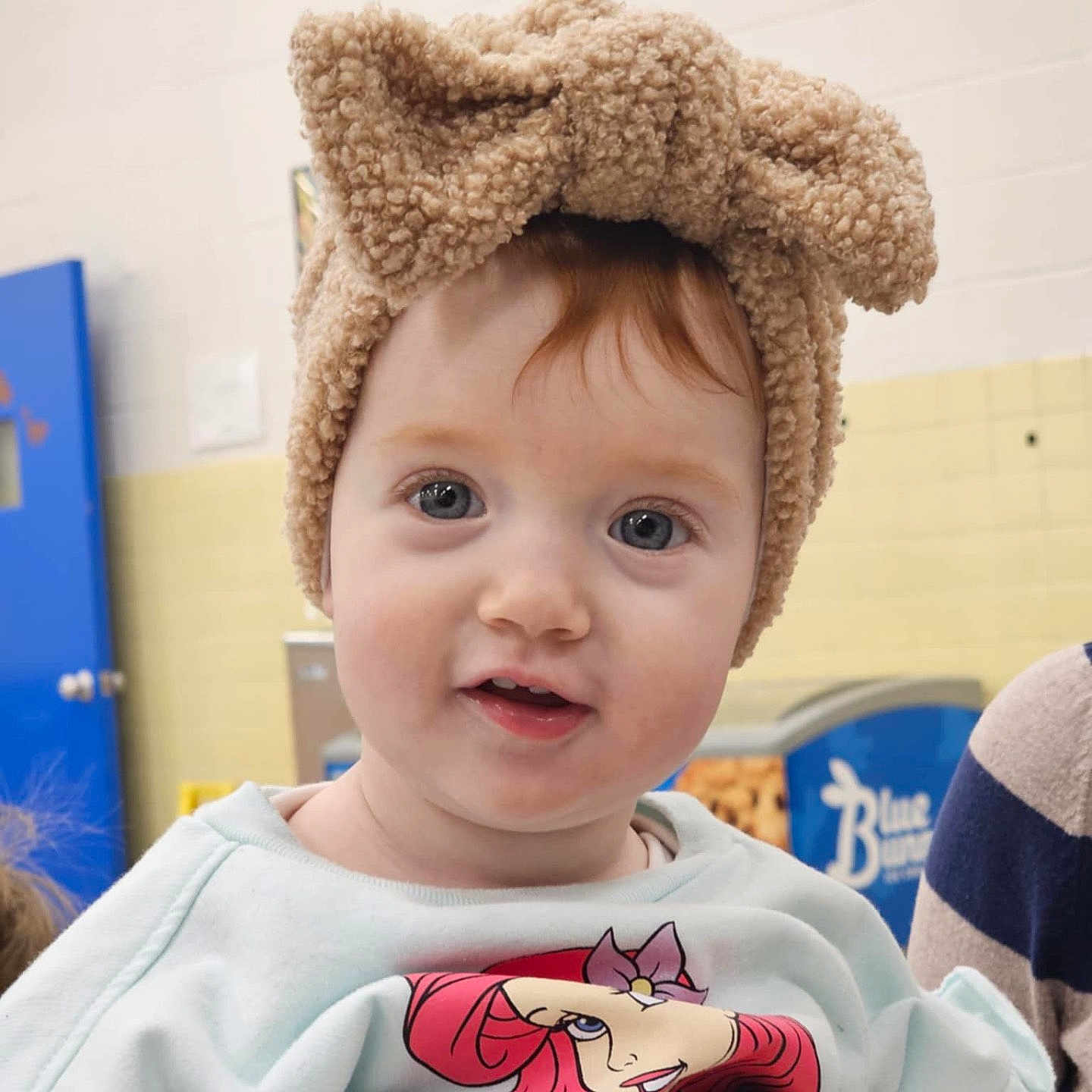 Haven is registered to the contest to win money with this photo: baby, bodypart, bonnet, cap, clothing, costume, face, finger, hand, happy, hat, head, indoors, knitwear, person, photography, portrait, smile, sweater, t_shirt