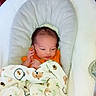 Orion joined the competition — help win amazing prizes! baby, infant, child, portrait, sitting, blanket, swaddle, orange_clothing, white_blanket, sheep_pattern, baby_seat, cushion, indoors, home, facial_expression, eyes_open, hand, brown_hair, cozy, photography