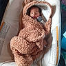 baby, baby_seat, blanket, car_seat, child, closed_eyes, cozy, cushion, face, gray_mitten, head, indoors, infant, newborn, peaceful, peach_blanket, photography, portrait, sleeping, swaddled