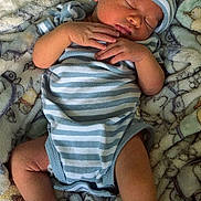 Samir joined the competition — help win amazing prizes! baby, blanket, child, cozy, cute, feet, hands, hat, indoors, infant, newborn, patterned_blanket, peaceful, person, portrait, resting, sleeping, socks, soft_texture, striped_clothing